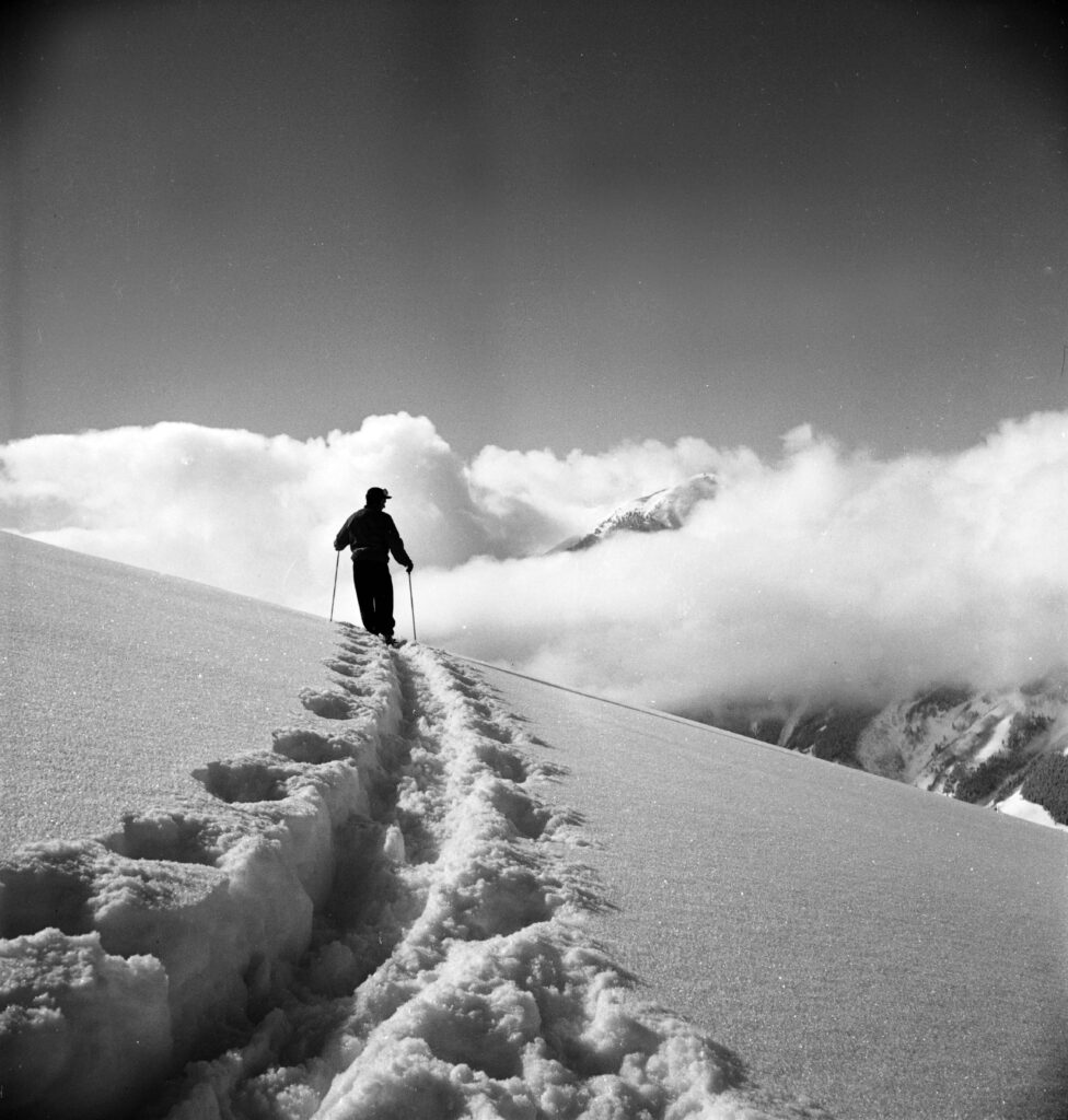 One 2.25" negative and b/w photograph of Gale Spence standing in a snow-covered field near Midway. His are the only tracks in the photo, 1952-.