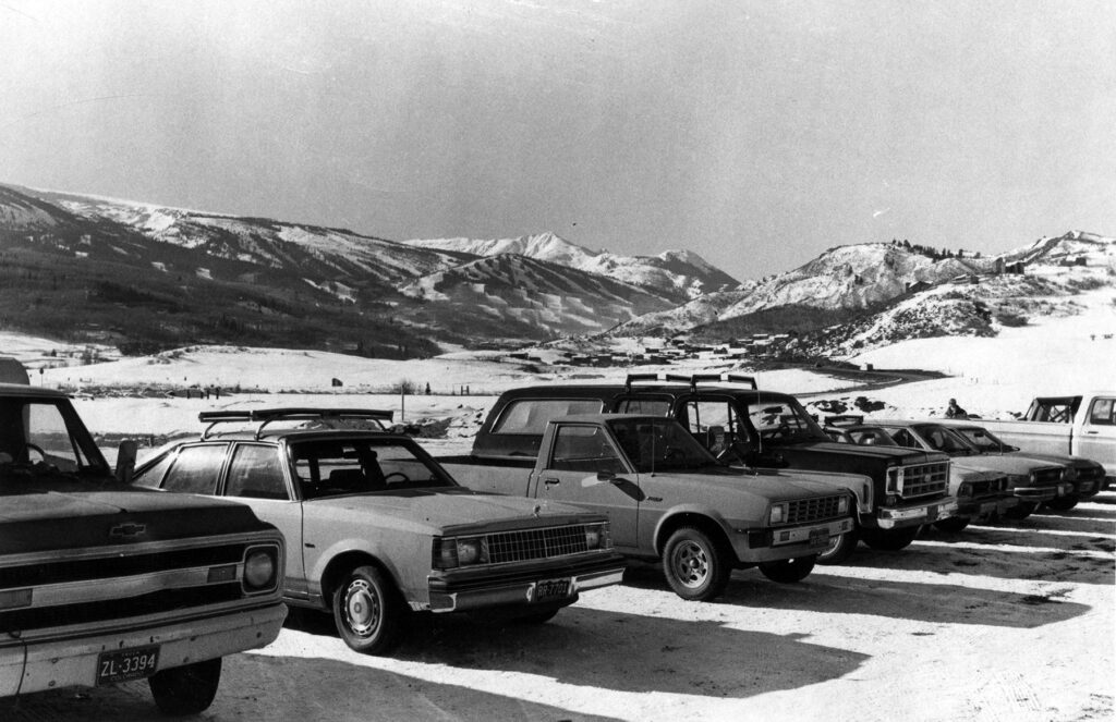 One b/w photograph of the Rodeo Lot (parking lot) at Snowmass, which was "working well." This image is in the Aspen Times on January 10, 1980 page 20 B. This was where skiers could catch a local bus to the ski area and park all day for free.