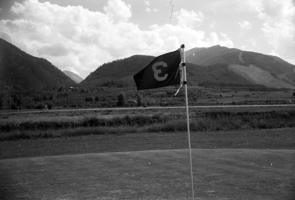 One 35mm b/w negative of the newly-opened Aspen Golf Course, 1961. This image is in the Aspen Flyer on July 18, 1961, with a caption reading "No. 3 green looking towards Aspen Highlands ski area."